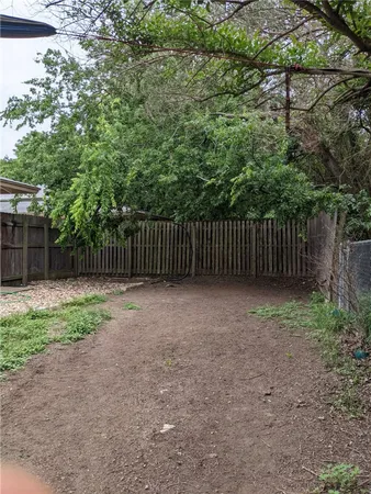 a view of outdoor space with wooden fence