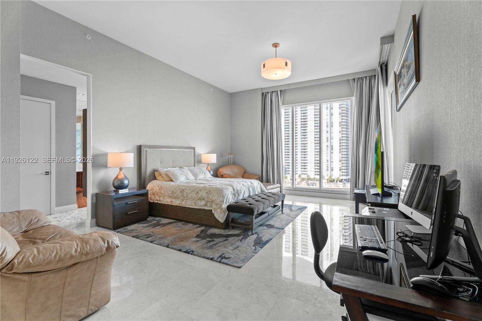 900 Brickell Key Boulevard, Unit 803 Miami, FL 33131 - Photo 14 of 38 a bedroom with furniture and a flat screen tv