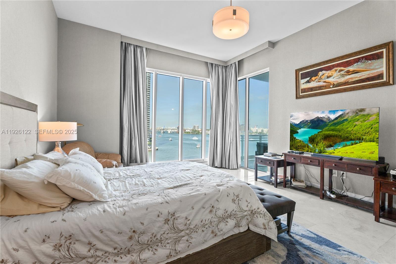 900 Brickell Key Boulevard, Unit 803 Miami, FL 33131 - Photo 15 of 38 a bedroom with a bed and a flat screen tv