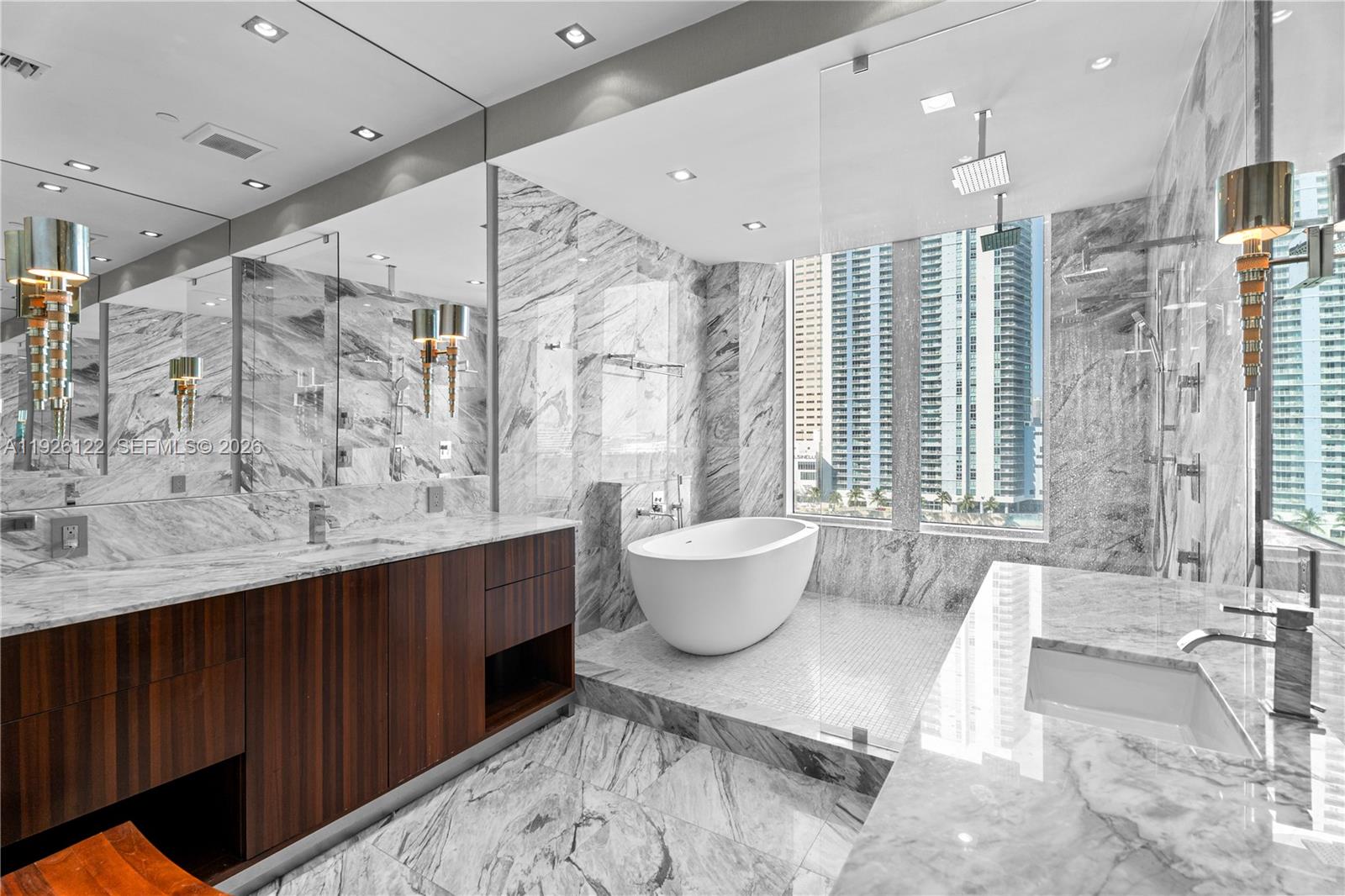 900 Brickell Key Boulevard, Unit 803 Miami, FL 33131 - Photo 17 of 38 a large bathroom with a large tub and sink