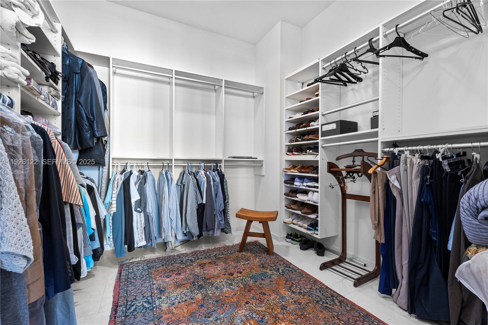 900 Brickell Key Boulevard, Unit 803 Miami, FL 33131 - Photo 19 of 38 a view of walk in closet with clothes and shoes
