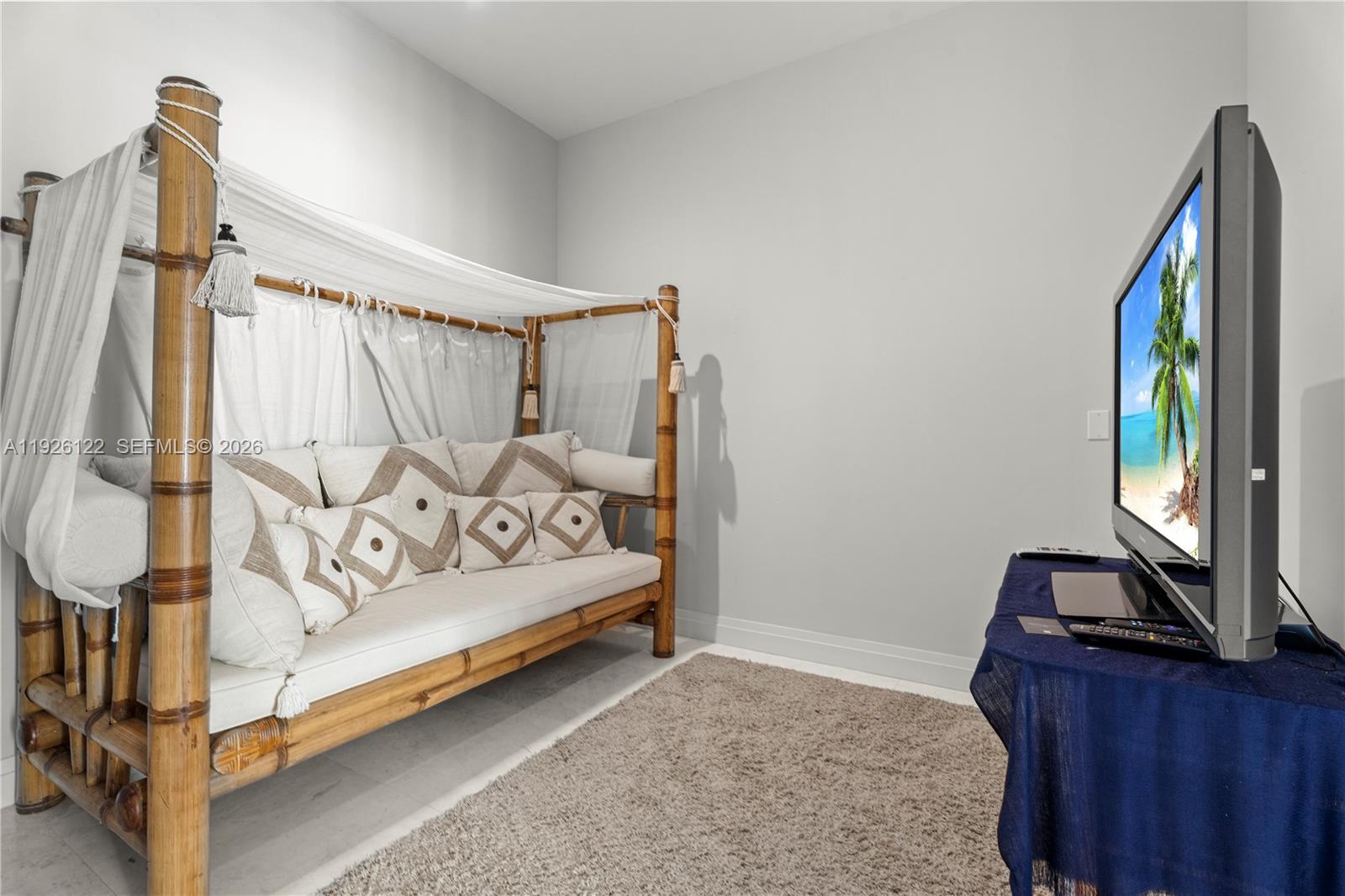 900 Brickell Key Boulevard, Unit 803 Miami, FL 33131 - Photo 20 of 38 a bedroom with a bed and a dresser
