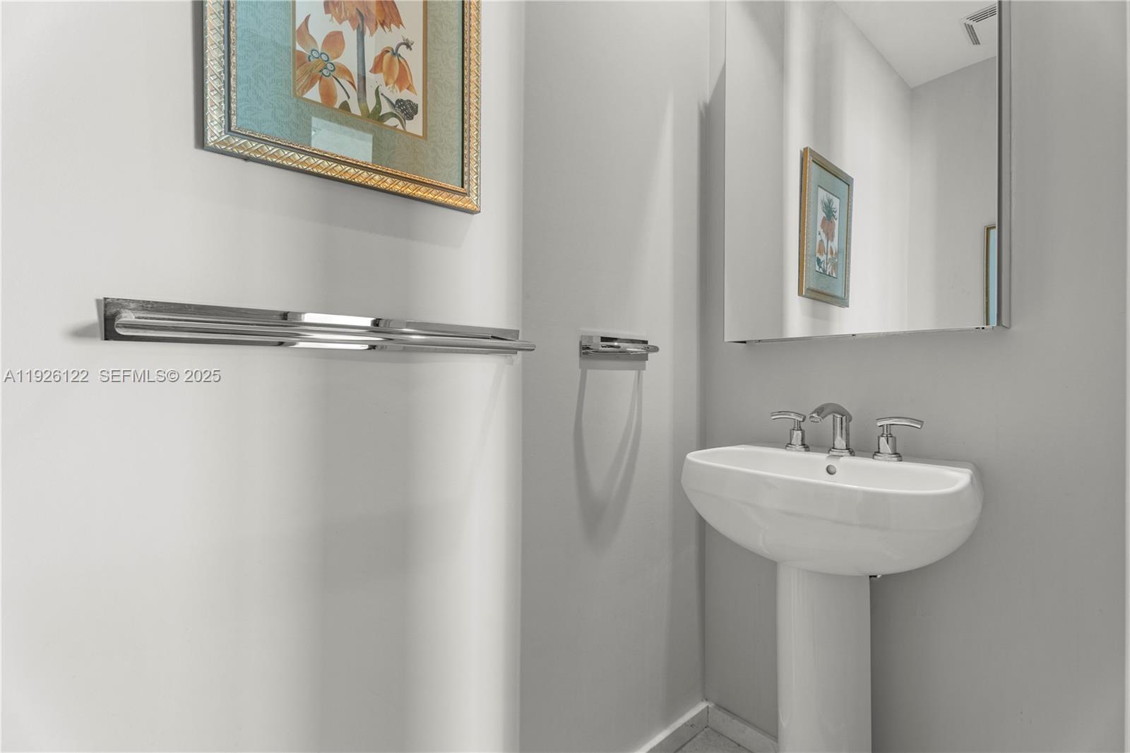 900 Brickell Key Boulevard, Unit 803 Miami, FL 33131 - Photo 21 of 38 a bathroom with a sink and mirror