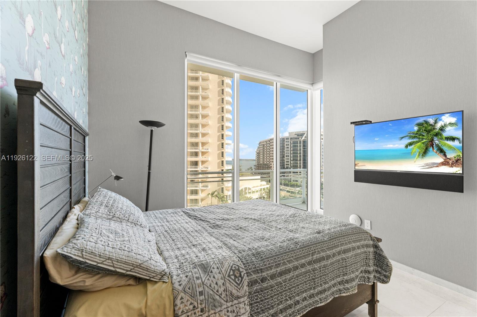 900 Brickell Key Boulevard, Unit 803 Miami, FL 33131 - Photo 22 of 38 a bedroom with a bed and a large window