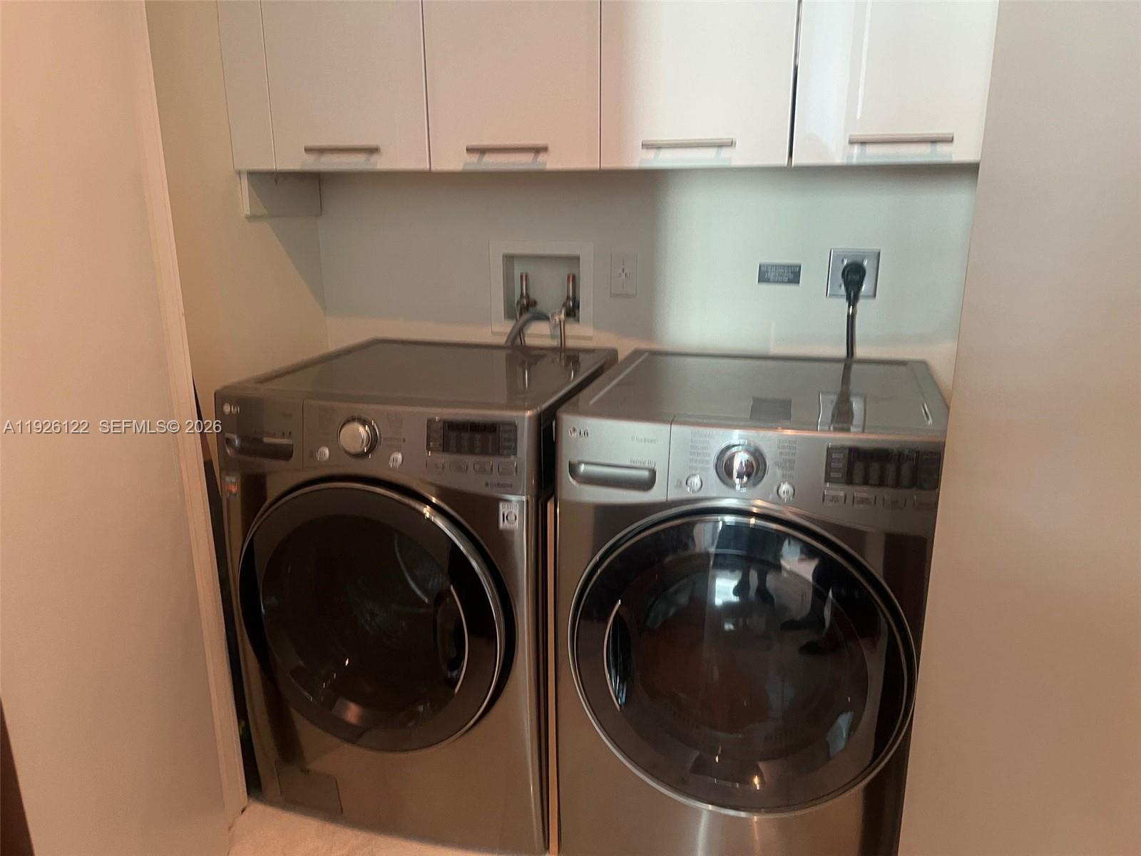 900 Brickell Key Boulevard, Unit 803 Miami, FL 33131 - Photo 36 of 38 a utility room with dryer and washer