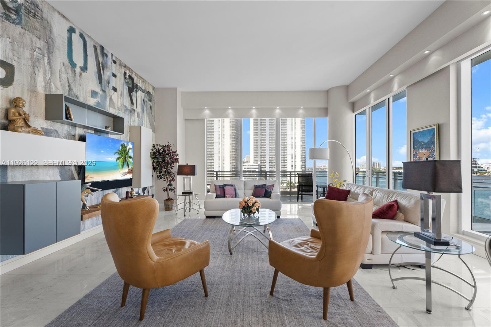900 Brickell Key Boulevard, Unit 803 Miami, FL 33131 - Photo 4 of 38 a living room with fireplace furniture and a large window