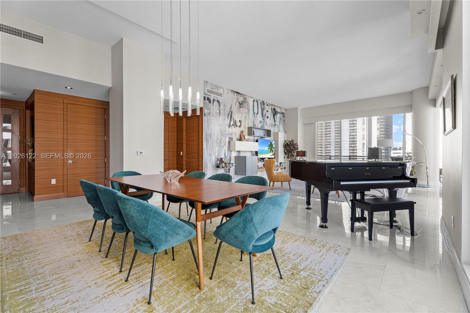 900 Brickell Key Boulevard, Unit 803 Miami, FL 33131 - Photo 8 of 38 a view of a dining room with furniture and chandelier