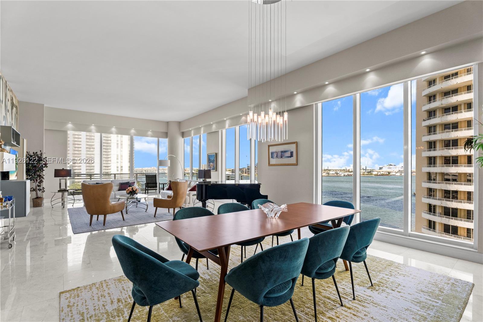 900 Brickell Key Boulevard, Unit 803 Miami, FL 33131 - Photo 9 of 38 a view of a dining room with furniture and wooden floor