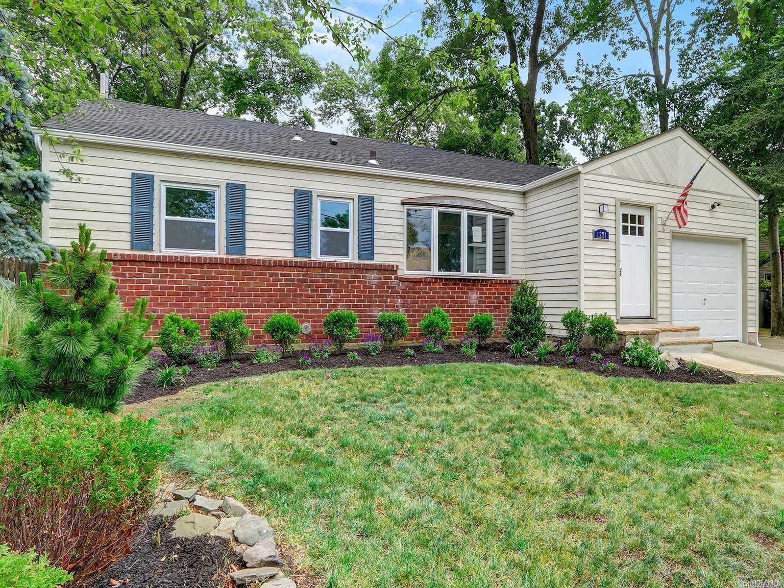 1271 Meadowbrook Road Merrick, NY 11566 - Photo 1 of 1 a front view of house with yard and green space