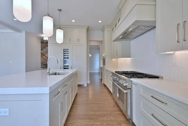 a kitchen with granite countertop a stove and a sink