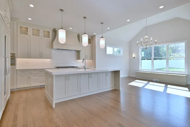 a large kitchen with a large counter top appliances and cabinets