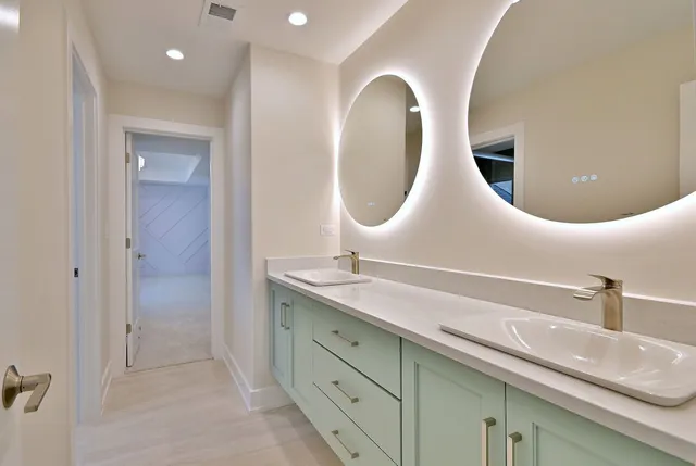 a bathroom with a double vanity sink and mirror