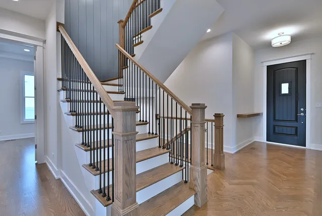 a view of entryway with wooden floor and stairs