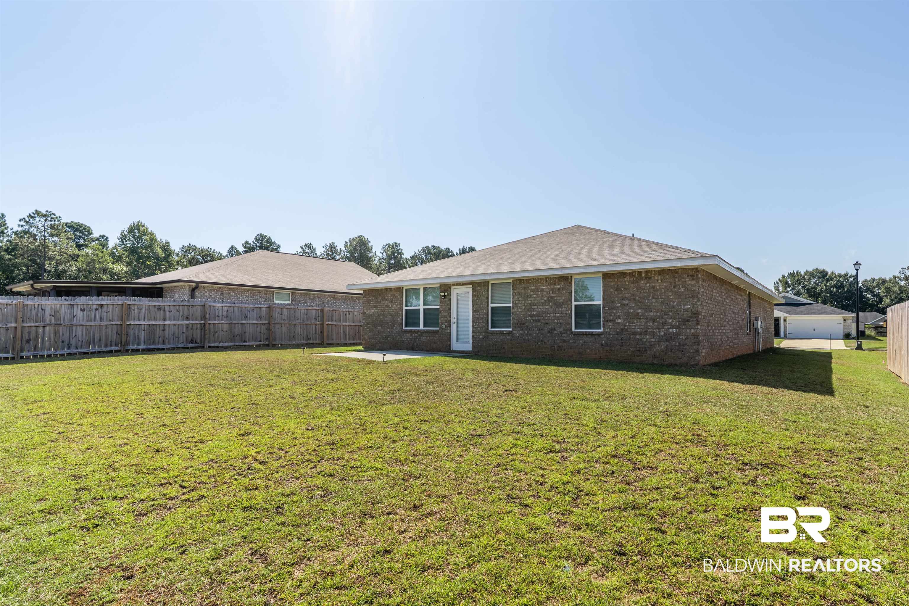 1906 Stonepine Drive South Semmes, AL 36575 - Photo 26 of 30 Back of house with brick siding, a patio, and a fenced backyard