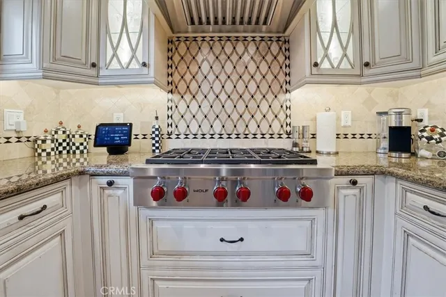 a bedroom with a large bed a chandelier and windows