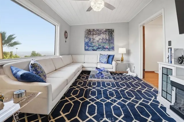 a roof deck with a table and chairs under an umbrella with a barbeque
