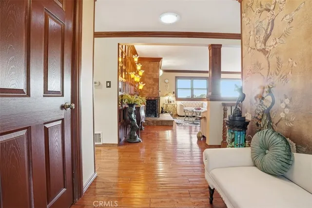 a living room with furniture a fireplace and a large window