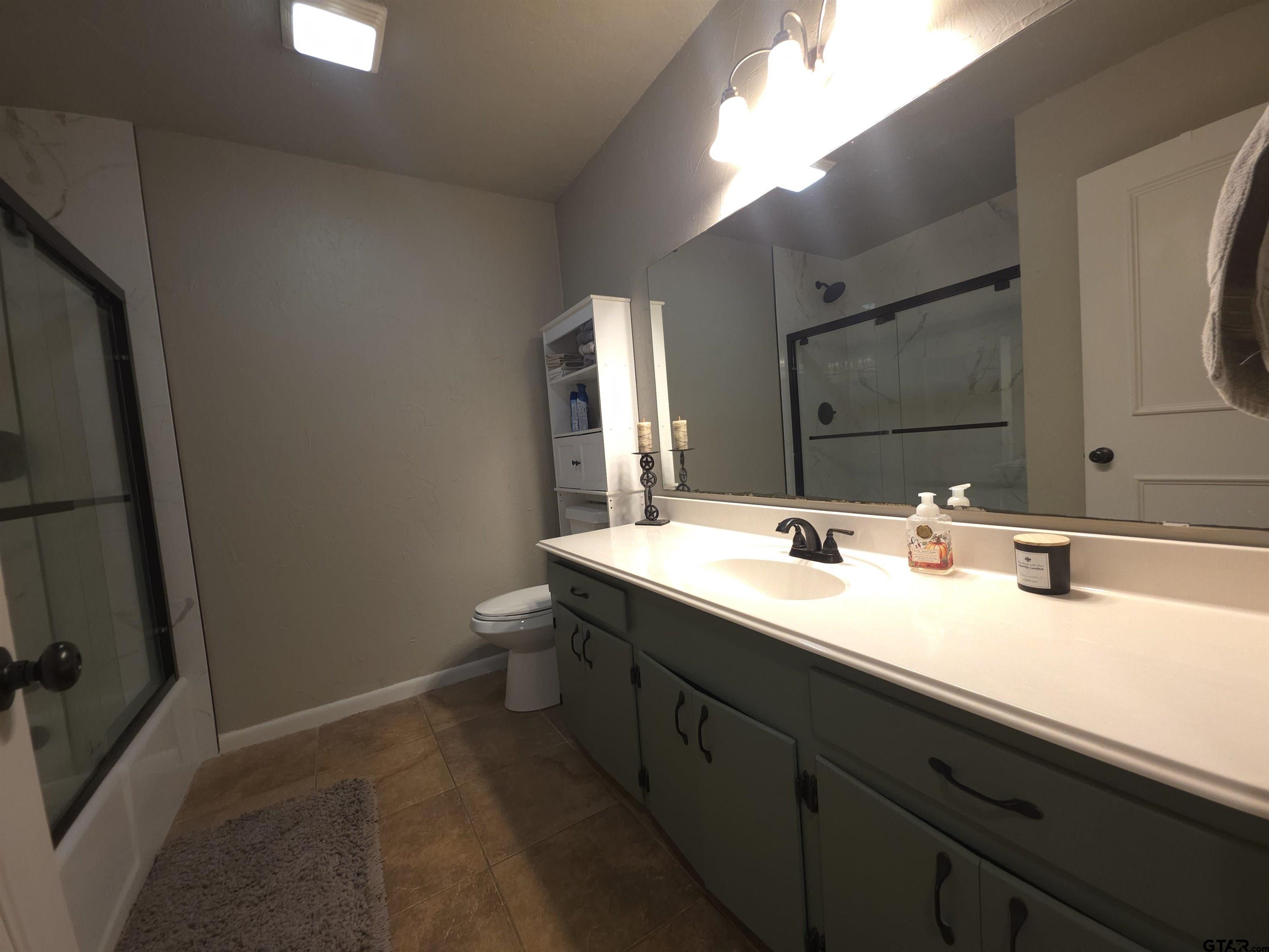 109 Randal Lane Pittsburg, TX 75686 - Photo 13 of 22 a bathroom with a sink and a mirror