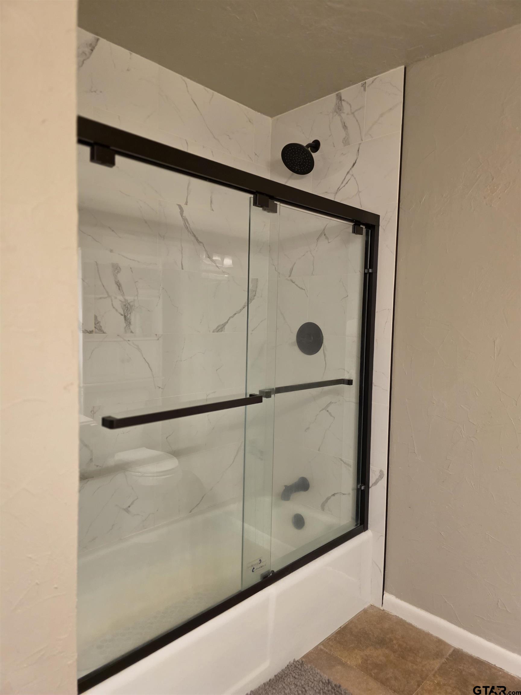 109 Randal Lane Pittsburg, TX 75686 - Photo 14 of 22 a bathroom with a glass shower door