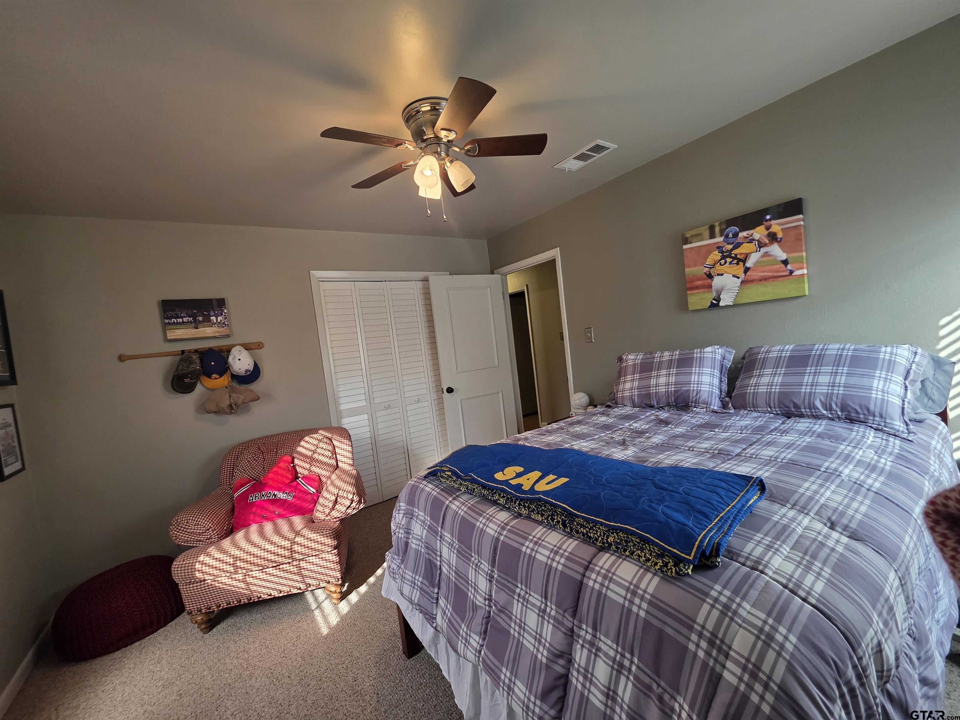 109 Randal Lane Pittsburg, TX 75686 - Photo 16 of 22 a bedroom with a bed and a chandelier