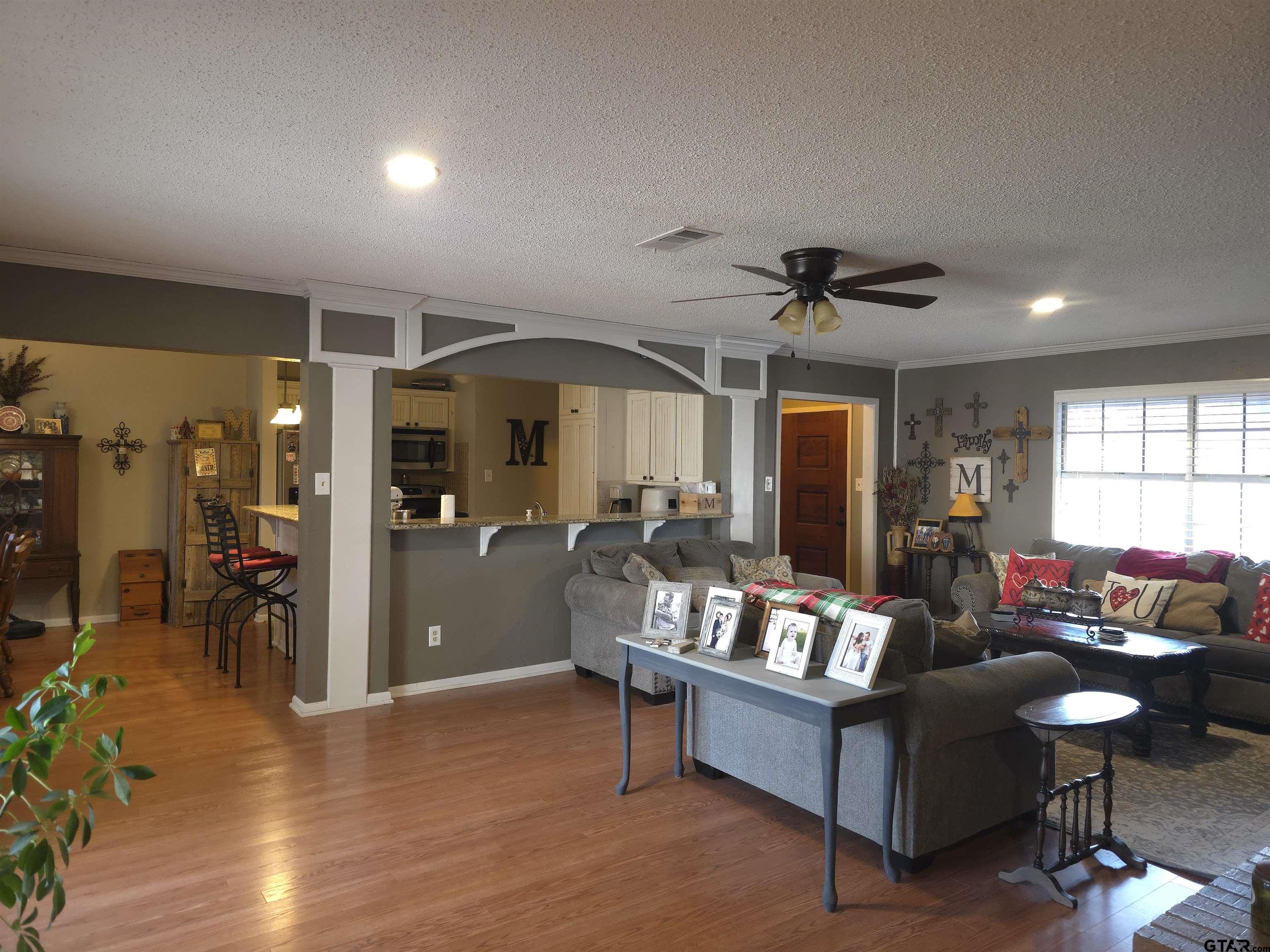 109 Randal Lane Pittsburg, TX 75686 - Photo 3 of 22 a living room with furniture a ceiling fan and a window