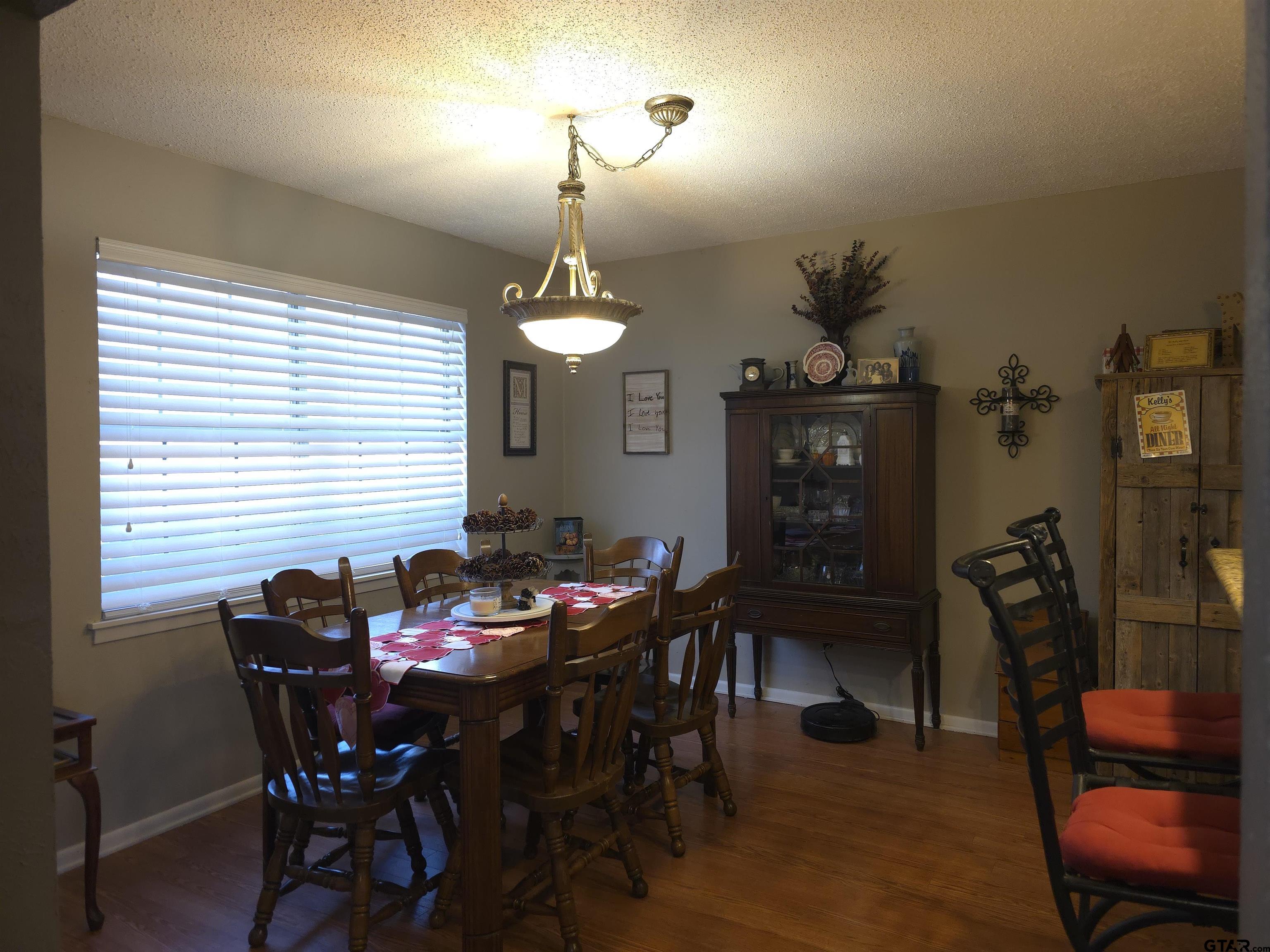 109 Randal Lane Pittsburg, TX 75686 - Photo 4 of 22 a view of a dining room with furniture and chandelier