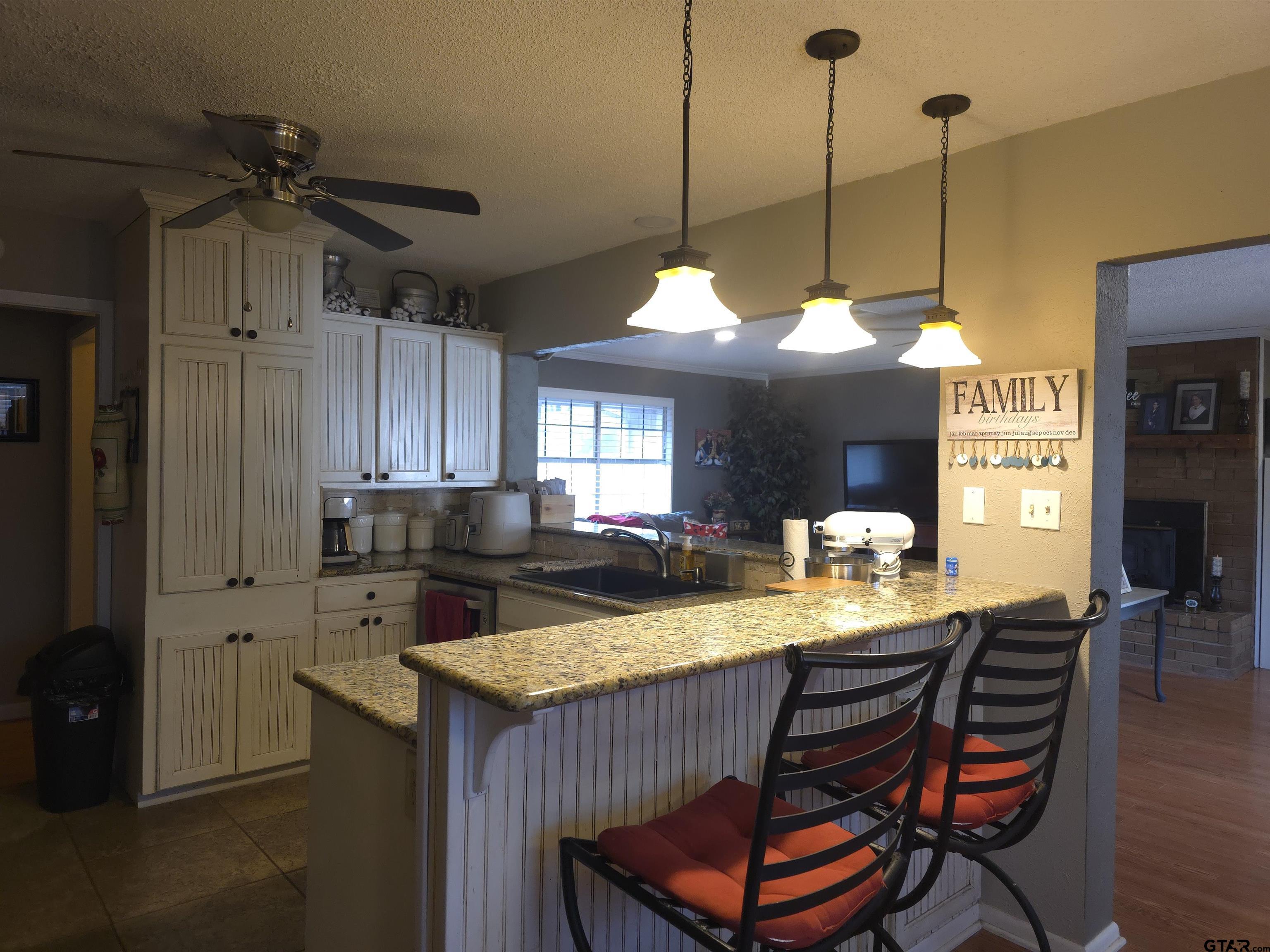 109 Randal Lane Pittsburg, TX 75686 - Photo 5 of 22 a view of a dining room and livingroom with furniture wooden floor a chandelier