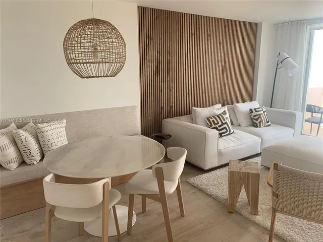 a living room with furniture a rug and a window