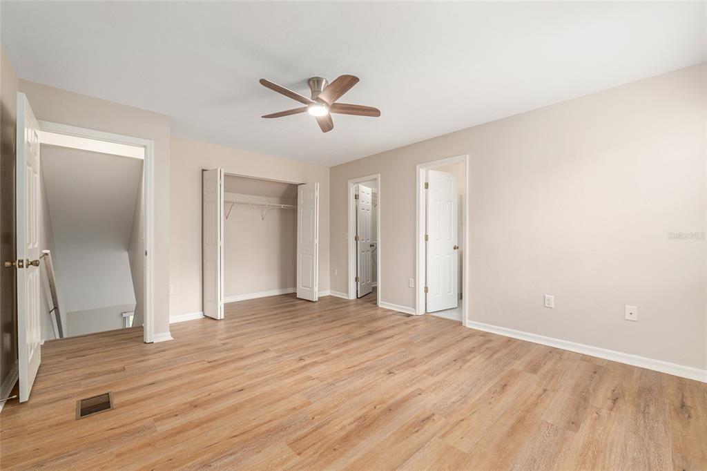 9755 Southwest 52nd Road Gainesville, FL 32608 - Photo 25 of 43 a view of empty room with wooden floor and fan