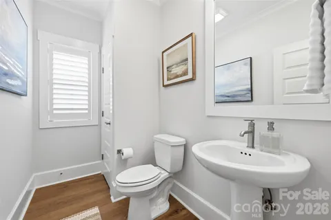 a bathroom with a sink toilet and a mirror