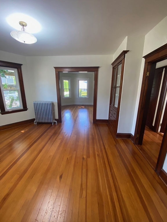 14 Welton Road Boston, MA 02132 - Photo 15 of 31 an empty room with wooden floor and windows