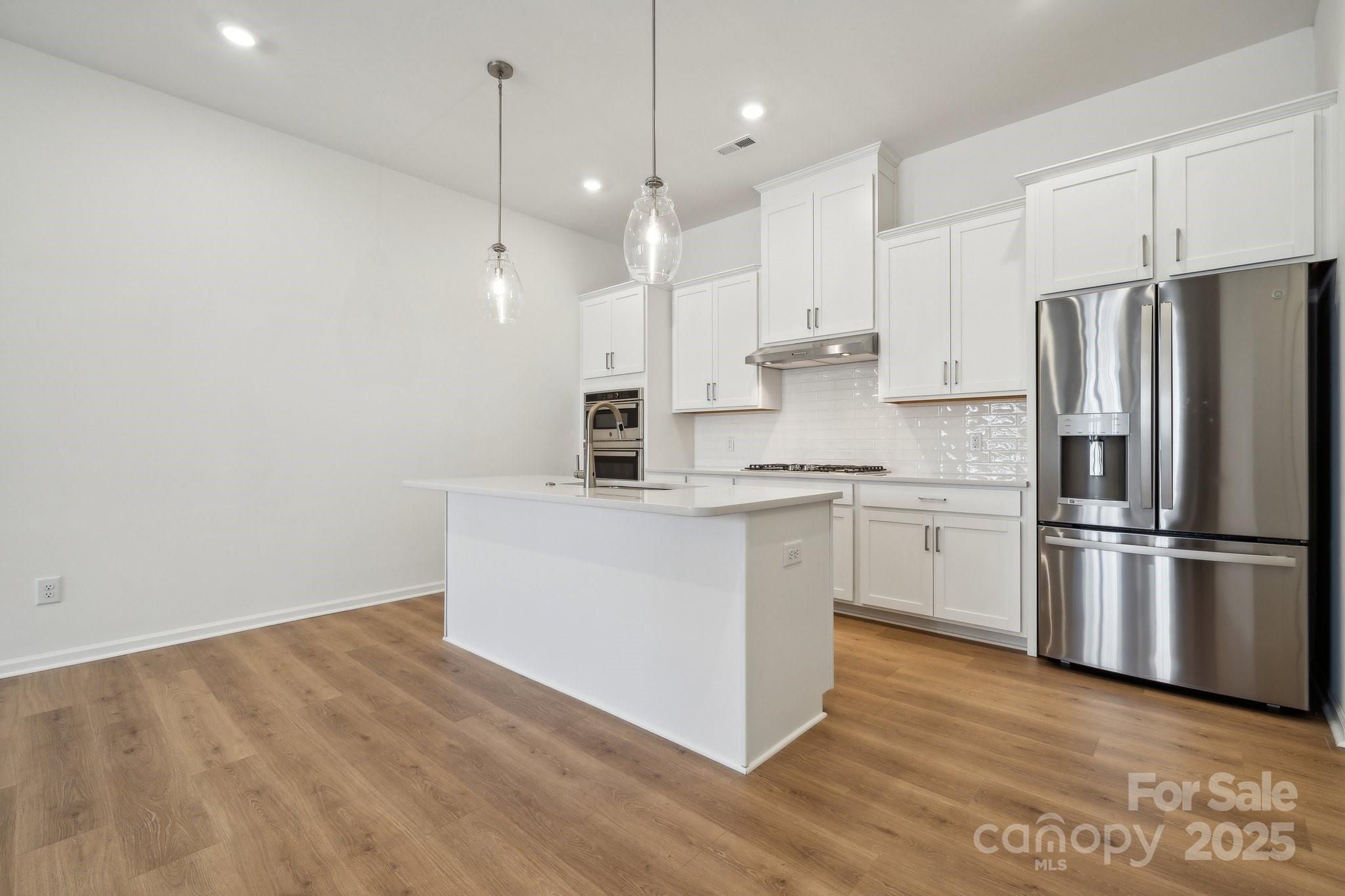 3110 Beacon Hts Road Indian Land, SC 29707 - Photo 3 of 38 a kitchen with white cabinets and stainless steel appliances