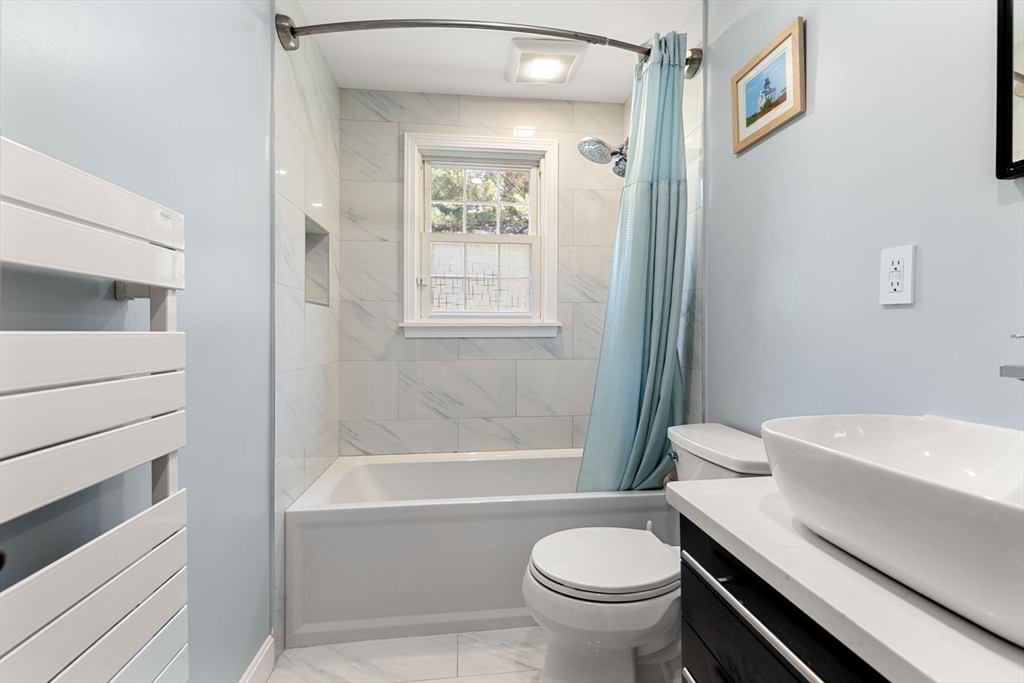 30 Granite Street Dedham, MA 02026 - Photo 11 of 36 a bathroom with a sink a toilet and a bathtub
