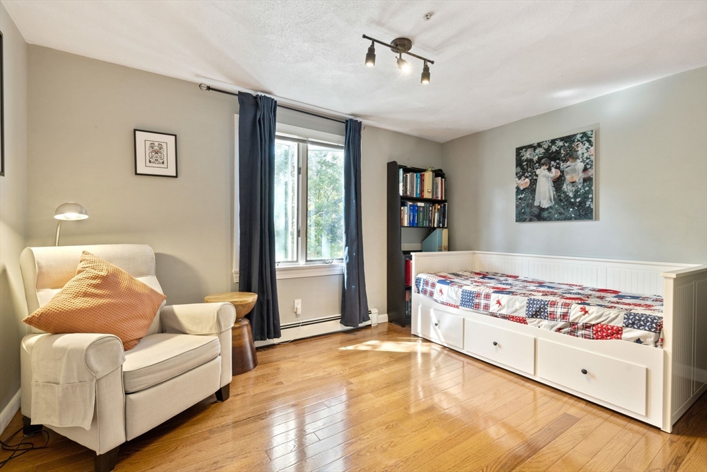 30 Granite Street Dedham, MA 02026 - Photo 13 of 36 a living room with a baby bed furniture and next to a window