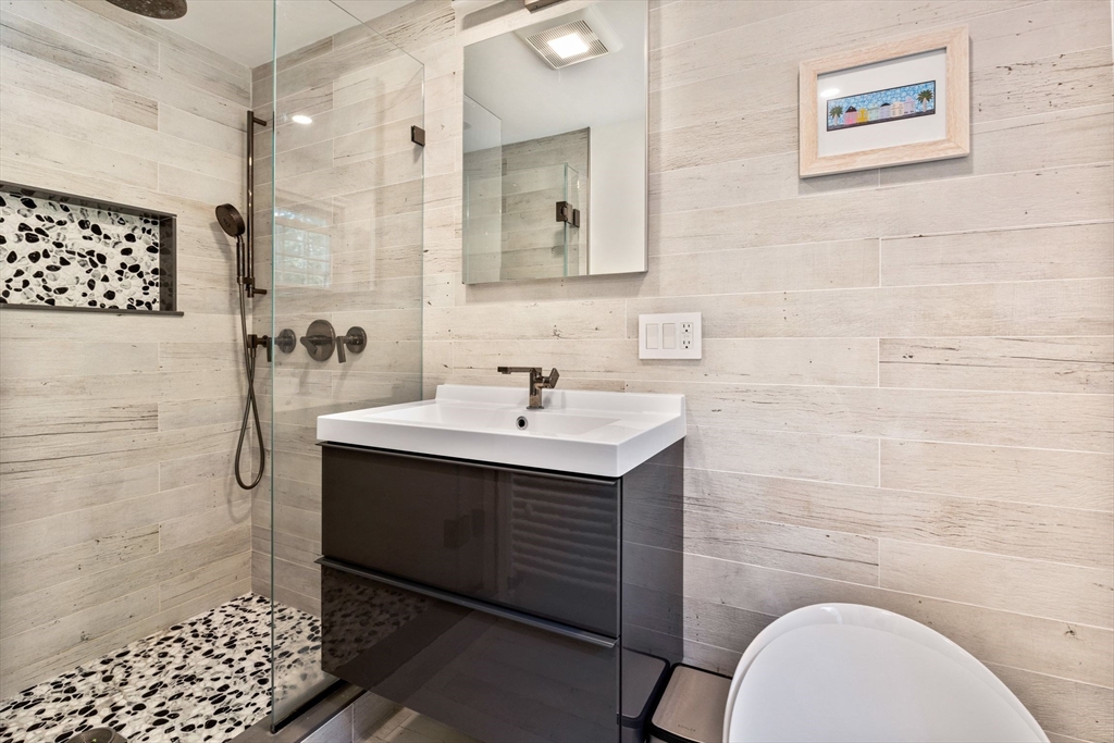 30 Granite Street Dedham, MA 02026 - Photo 18 of 36 a bathroom with a sink toilet and shower