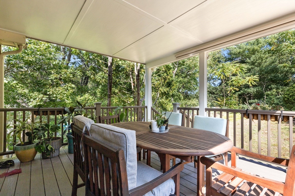 30 Granite Street Dedham, MA 02026 - Photo 26 of 36 a view of a balcony with chairs and wooden floor