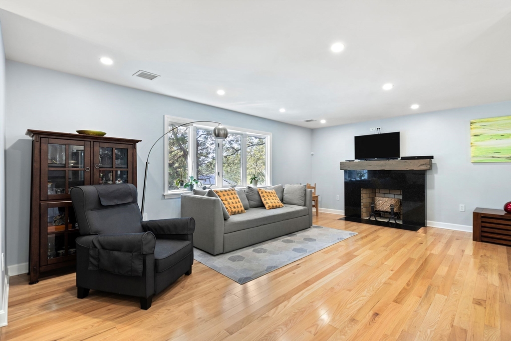 30 Granite Street Dedham, MA 02026 - Photo 3 of 36 a living room with furniture a fireplace and a flat screen tv