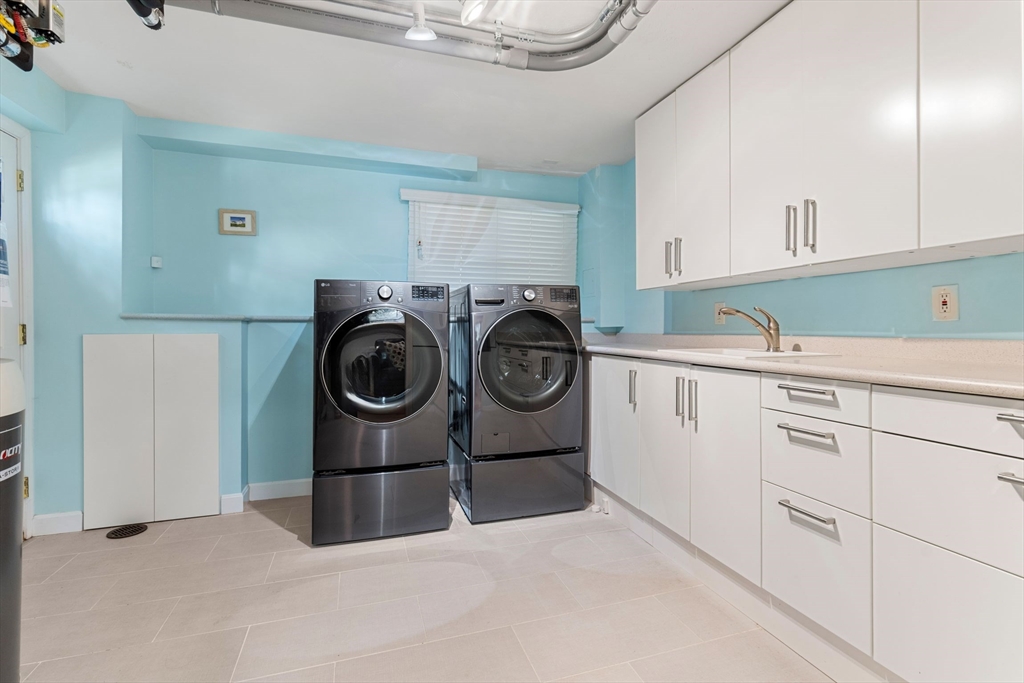 30 Granite Street Dedham, MA 02026 - Photo 34 of 36 a utility room with sink dryer and washer