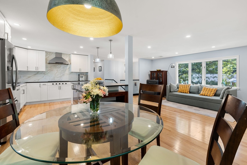 30 Granite Street Dedham, MA 02026 - Photo 6 of 36 a living room with dining table furniture and a chandelier