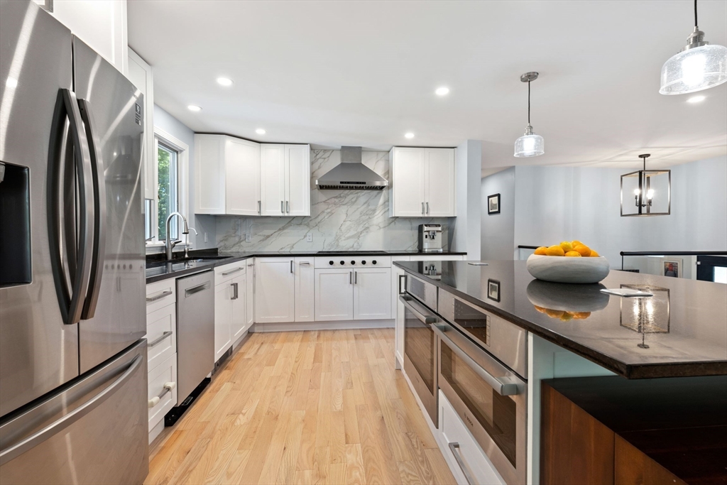 30 Granite Street Dedham, MA 02026 - Photo 7 of 36 a kitchen with stainless steel appliances granite countertop a sink refrigerator and cabinets