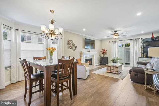 a view of a dining room with furniture wooden floor and chandelier