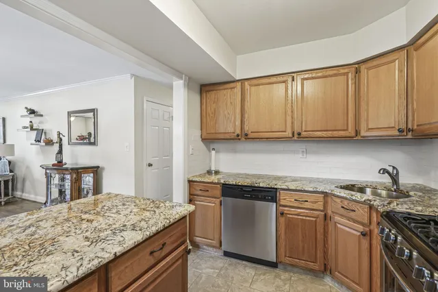 a kitchen with stainless steel appliances granite countertop a stove and a sink