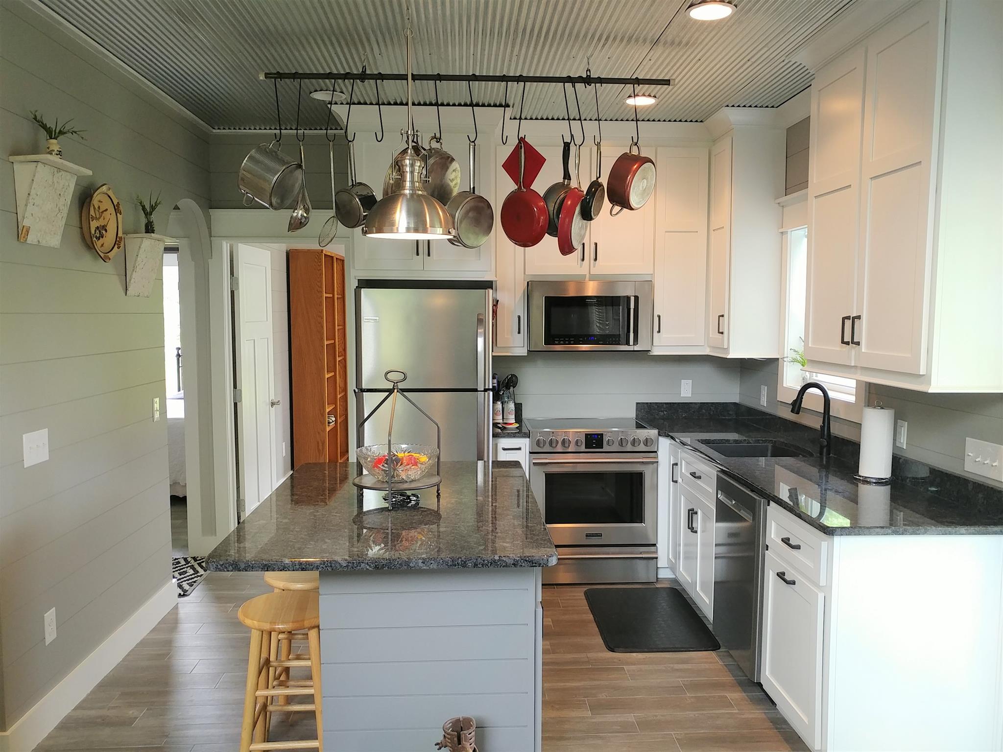 4055 Flewellyn Road Springfield, TN 37172 - Photo 8 of 28 a kitchen with stainless steel appliances granite countertop a sink and a stove