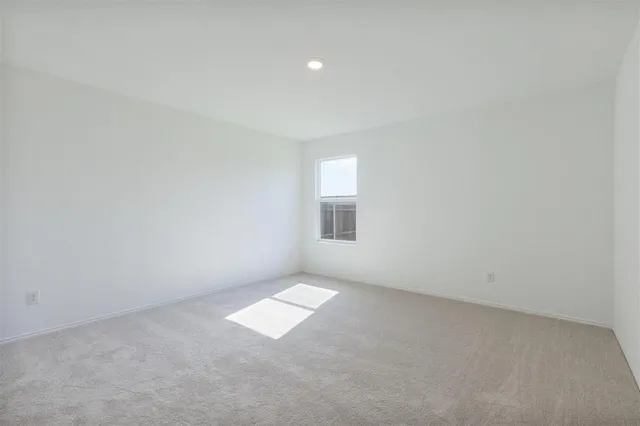 an empty room with a empty space and window