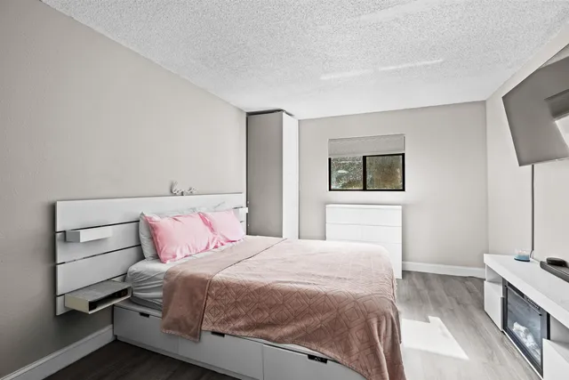 a bedroom with a bed and a potted plant