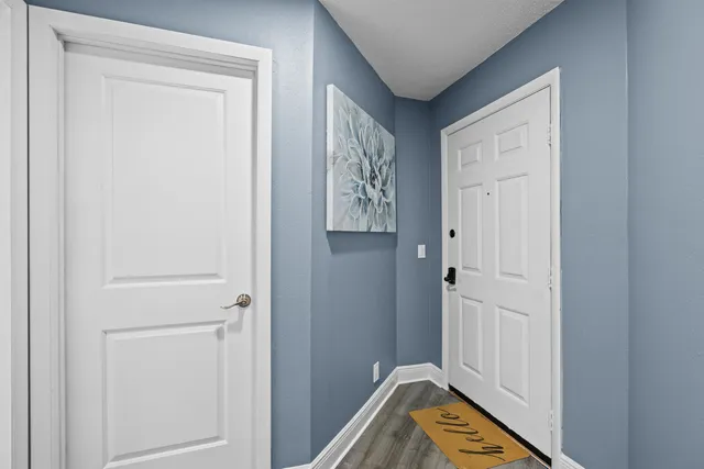 a view of a hallway with entryway door