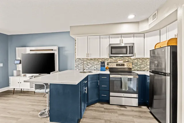 a kitchen with a refrigerator stove and microwave