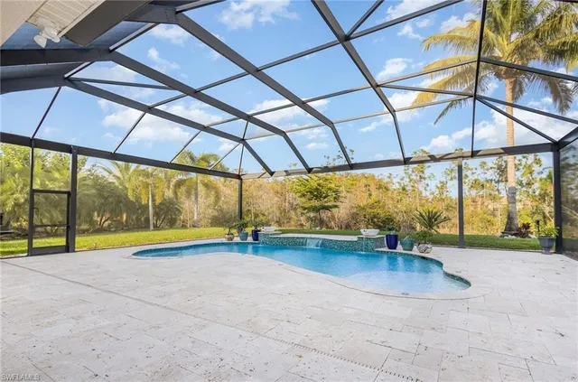 an empty room with window and pool table