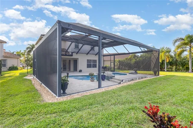 a view of a house with a backyard porch and sitting area