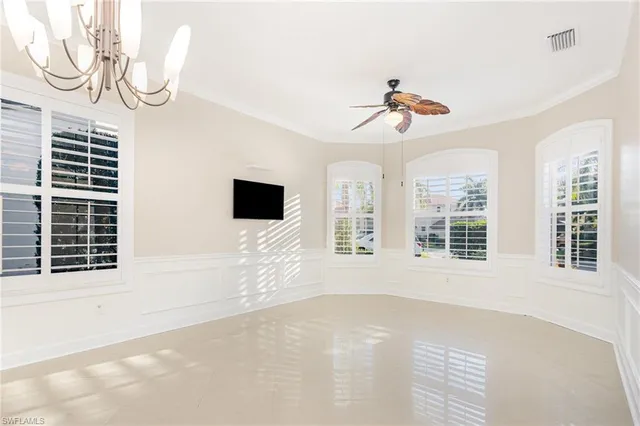 a view of an empty room with a window and a ceiling fan